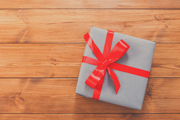 Present in gift box on wood background with copy space