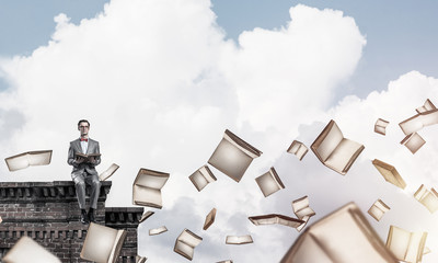 Young businessman or student studying the science and books flyi