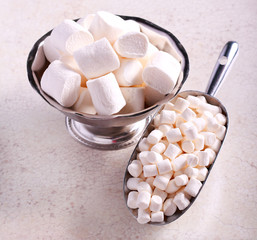 Marshmallows in metal scoop and metal bowl