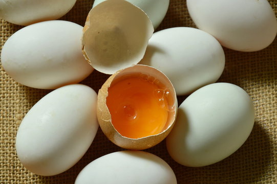 yolk in crack brown egg on sackcloth