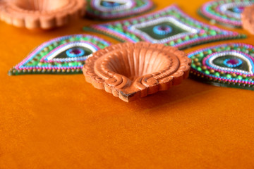 Fototapeta premium Rangoli design around Diwali lamp Indian Festival