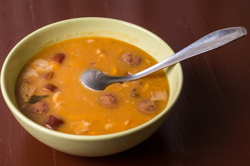 Closeup macro angle of cooked beans with sausages served in the bowl