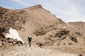 Man riding a bike in the high mountains of Sierra Nevada, Spain