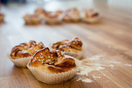 Cinnamon buns on wooden table close up