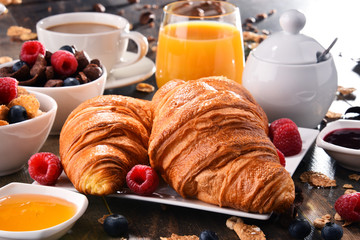 Breakfast served with coffee, juice, croissants and fruits