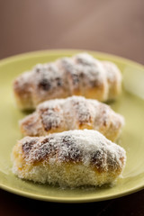 Closeup macro baked rolls with coconut served on the plate