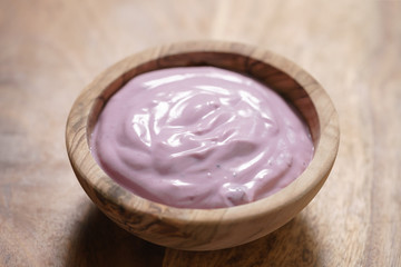blueberry yogurt in wood bowl