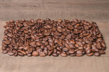 Background of coffee beans on a wooden board close up