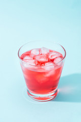 Sparkling red color drinks with water soda and ice in glass