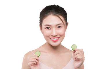 Young asian woman with cucumber slice in her hands isolated on white background