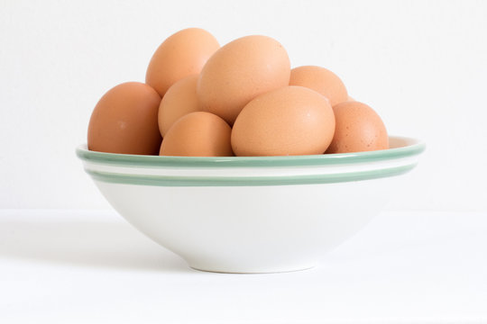 raw eggs in white bowl