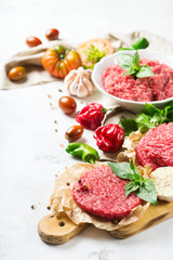 Homemade raw organic minced beef meat burger cutlet and vegetables