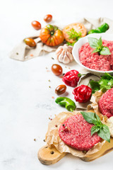 Homemade raw organic minced beef meat burger cutlet and vegetables