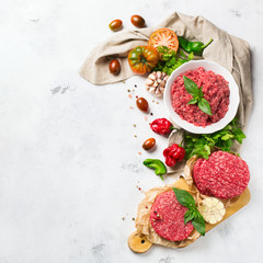 Homemade raw organic minced beef meat burger cutlet and vegetables