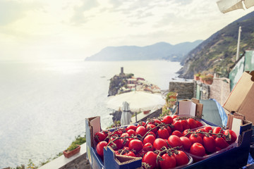tomatoes in a box exposed outdoors © Marino Bocelli