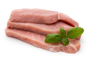 Fresh pork fillet with basil on a white background.