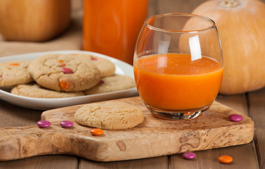 Homebaked Chewable Butter Biscuits With Colored Chocolate Sweets. Carrot Juice. Olive Tree Board. Autumn Leaves. Pumpkins.