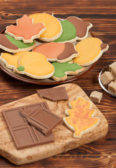 Autumn Style. Homebaked Decorated Sugar Cookies With Royal Icing. Olive Tree Wooden Board. Chocolate.