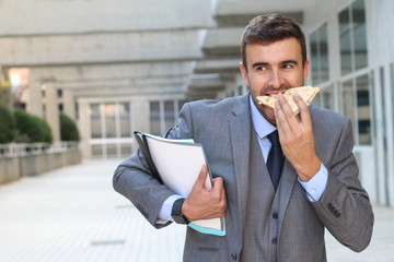 Businessman eating a sandwich on the go