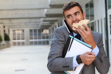 Businessman eating a sandwich on the go 