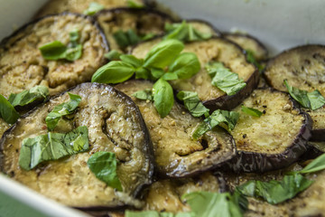 Fried and cooked aubergine with garlic basil in olive oil
