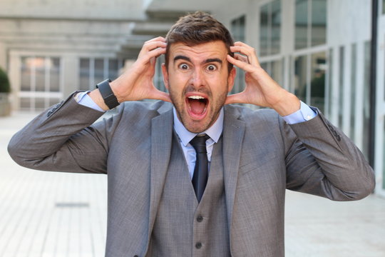 Businessman showing hysteria close up with copy space