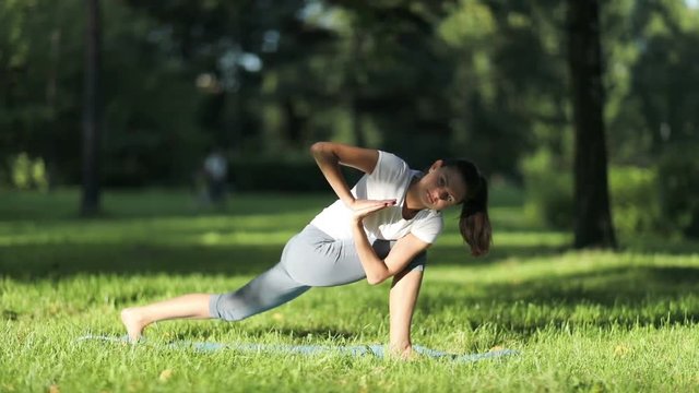 Woman practices yoga in the park. full HD 1080  50fps                               