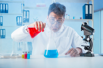 Funny mad chemist working in a laboratory