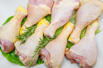 chicken thighs in a white plate on black wood table