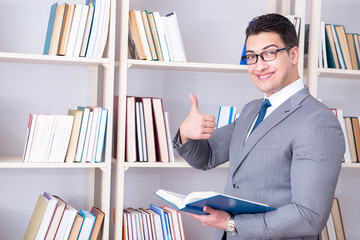 Businessman student reading a book studying in library