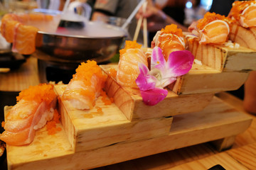 sashimi sushi set with chopsticks and soy - sushi roll with salmon and sushi roll with smoked eel selective focus.