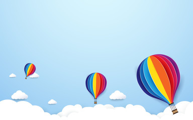 Fototapeta na wymiar colorful hot air balloons flying on blue sky background. Paper art and craft style design