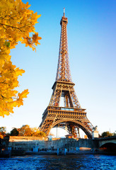 Fototapeta na wymiar Eiffel Tower over Seine river in soft sunset light of autumn sun, Paris, France