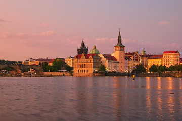 Fototapeta na wymiar Summer sunset panorama of the Old Town and Vltava river in Prague. Czech Republic