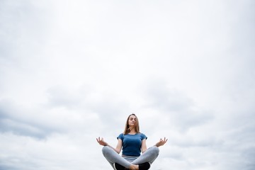 Girl does yoga in the sky