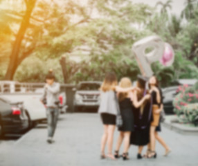 abstract blur: friendship group of teen girl (20s to 30s) poses and take picture from festival , party , event , university graduation ceremony with balloon