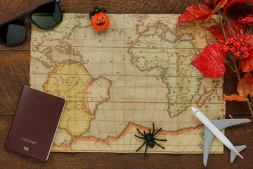 Above view of accessory Happy Halloween with items to travel background concept.Mix several object on the modern rustic brown wooden at home office desk.Equipment for traveler or teenage and adult.