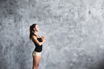 Fototapeta na wymiar Beautiful smiling young woman workout indoors, doing yoga exercise.