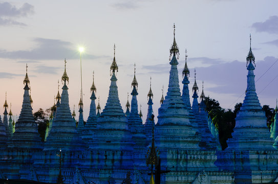 Aligned buddhist stupas surround Sandar Mu Ni Paya, on of the main shrines in Mandalay, Myanmar.