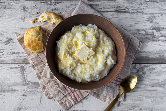 Southern Grits With Bisquit And Butter In Rustic Setting Top View