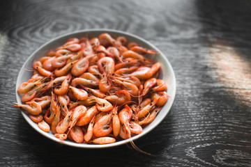 on a white plate on wooden background shrimp