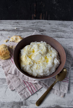 Southern Grits With Bisquit And Butter In Rustic Setting