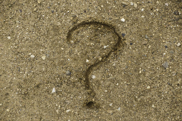 question mark drawn on the sand