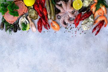 Seafood background - fresh mussels, molluscs, oysters, octopus, razor shells, shrimps, crab, crawfish, crayfish, seaweed, lemon, spices. Banner with copyspace