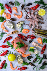 Obraz na płótnie Canvas Seafood background - fresh mussels, molluscs, oysters, octopus, razor shells, shrimps, crab, crawfish, crayfish, seaweed, lemon, spices. Banner with copyspace