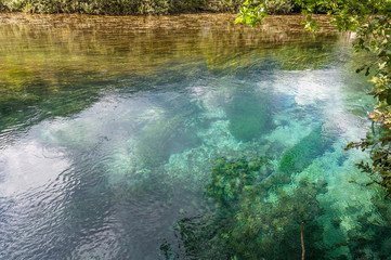 Visible river floor in transparent and crystalline waters of Livenza river source, Santissima, Friuli, Italy