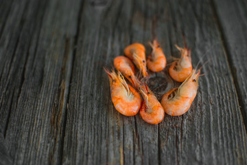 On a wooden table beautifully arranged shrimp