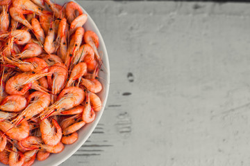 On a wooden table beautifully arranged shrimp