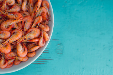 On a wooden table beautifully arranged shrimp