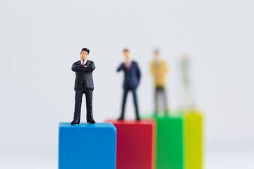 Miniature businessman :Graphs of various colors show the success of the work, Business teamwork concept.